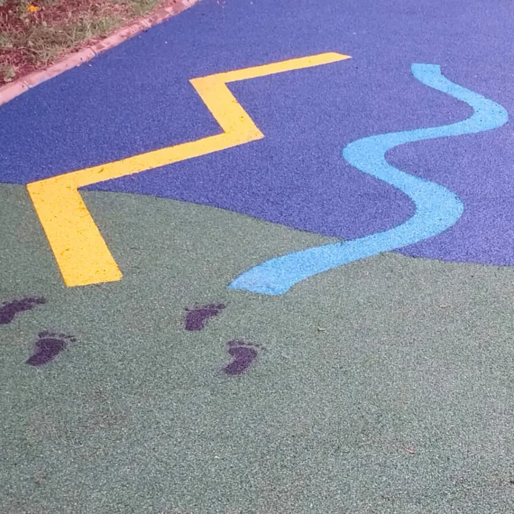 Um Playground com piso contínuo de paginação azul e amarela.